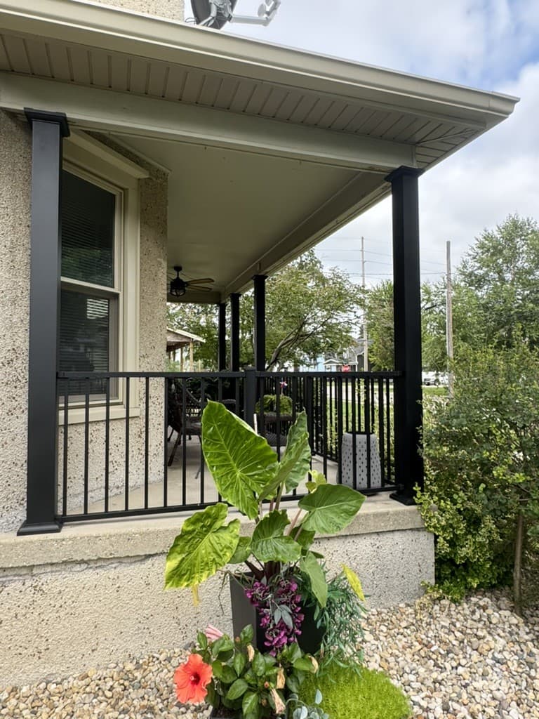 Covered porch with black aluminum railing, built by Xcel Outdoor Living in LaSalle County, Illinois